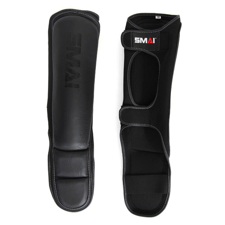 Black SMAI MMA shin guards with padded shin and foot protection