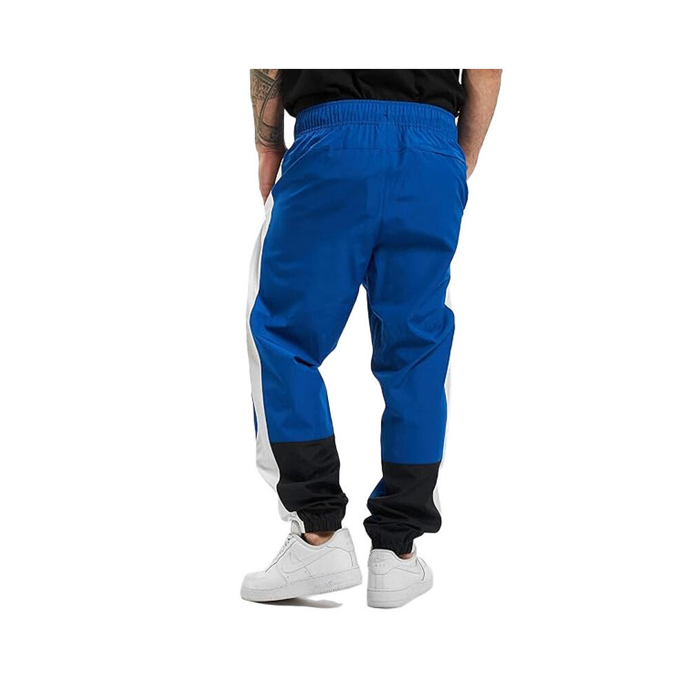 Pantalon de survêtement New Balance NB ATHLETICS WINDBREAKE 4/7
