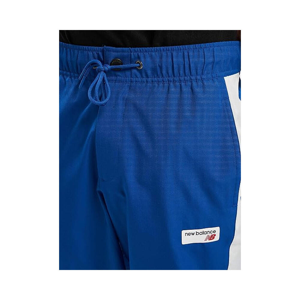 Pantalon de survêtement New Balance NB ATHLETICS WINDBREAKE 5/7