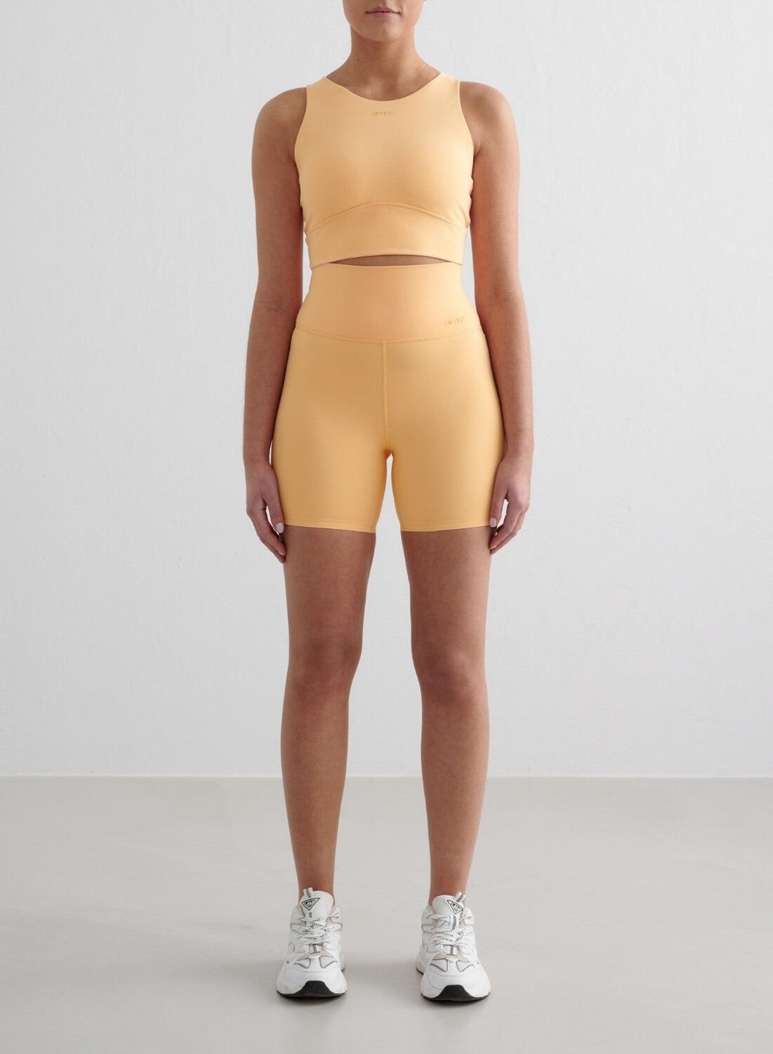 AIM'N Dames Pilates Short Midi Vochtafvoerend Lichtoranje