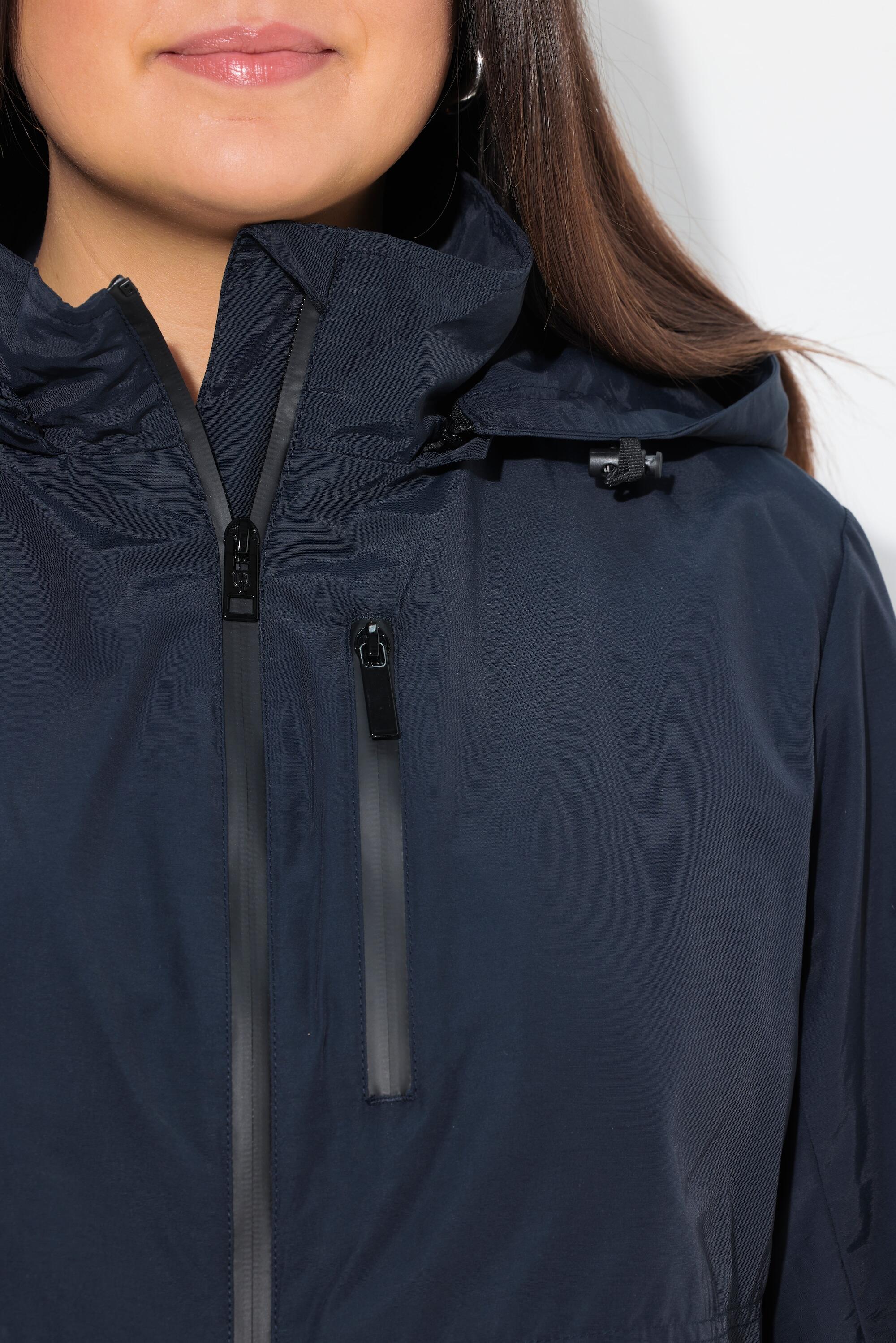 Femme Parka à capuche. Fentes latérales zippées. Poches zippées 5/7
