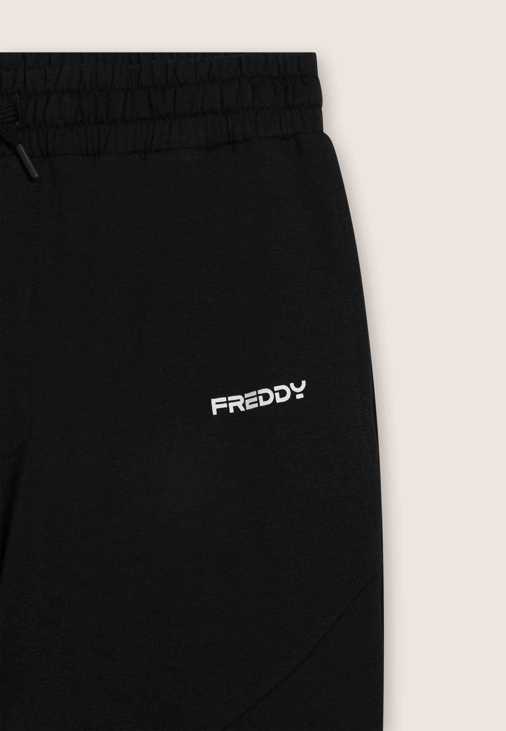Pantalón regular fit en felpa con estampado brillante y costuras 3/3