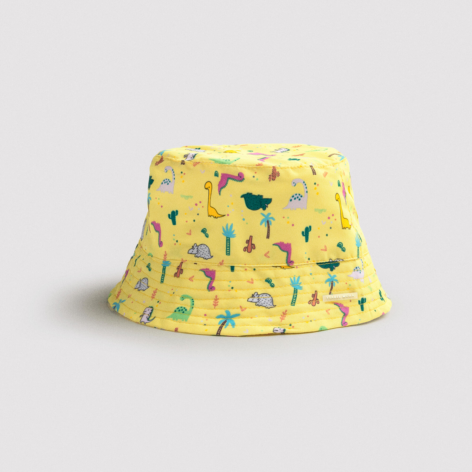 Gorro de playa bebé ala recta estampado dinosaurios amarillo 1/3