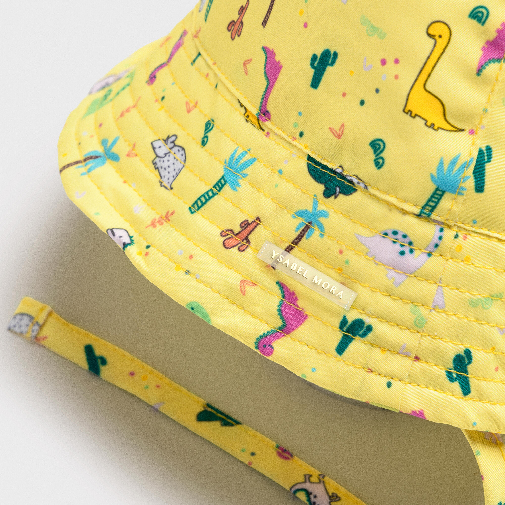 Gorro de playa bebé ala recta estampado dinosaurios amarillo 2/3