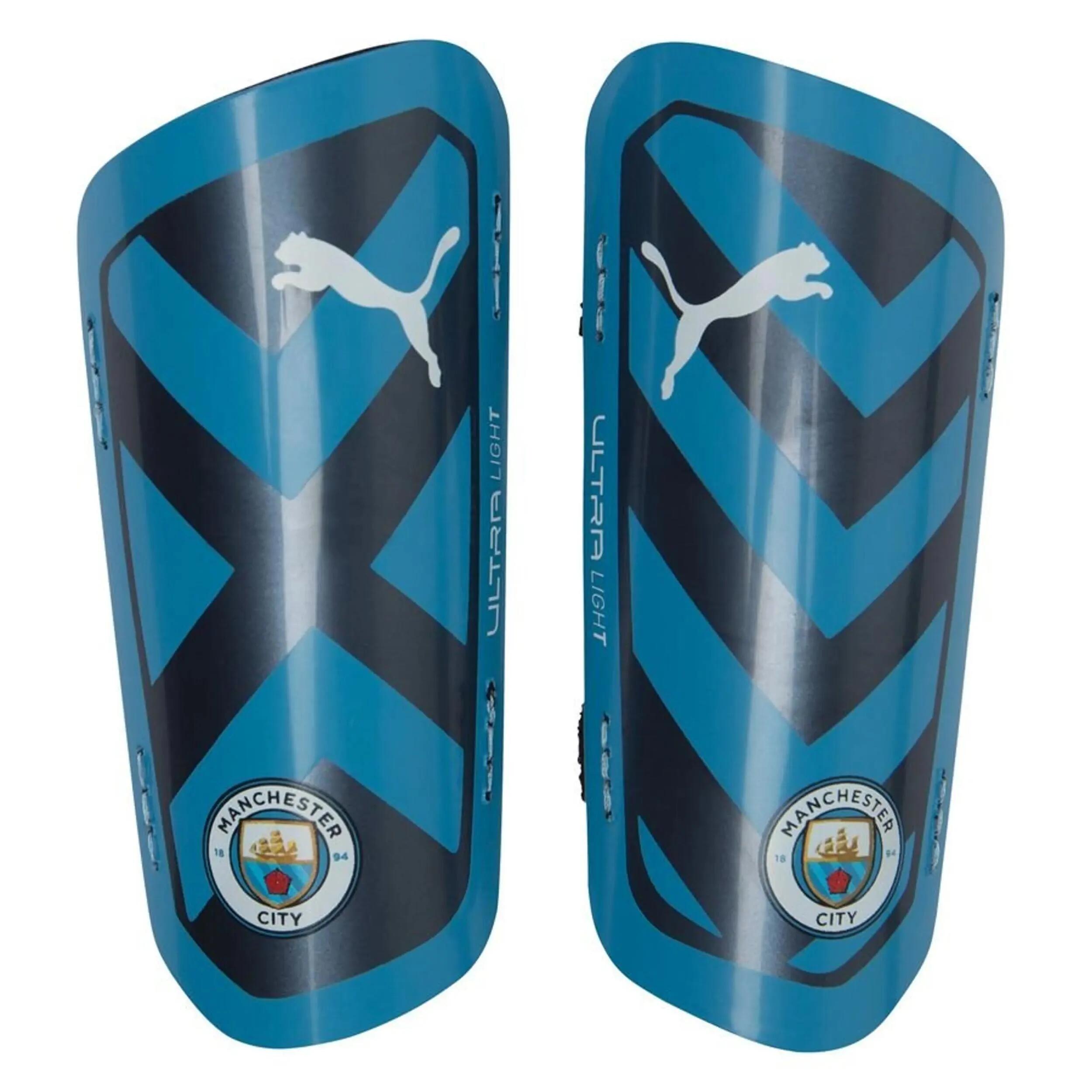 Protège-tibias Puma Man City Unisexe MCFC TR Ultra Light Strap bleu clair. 1/1