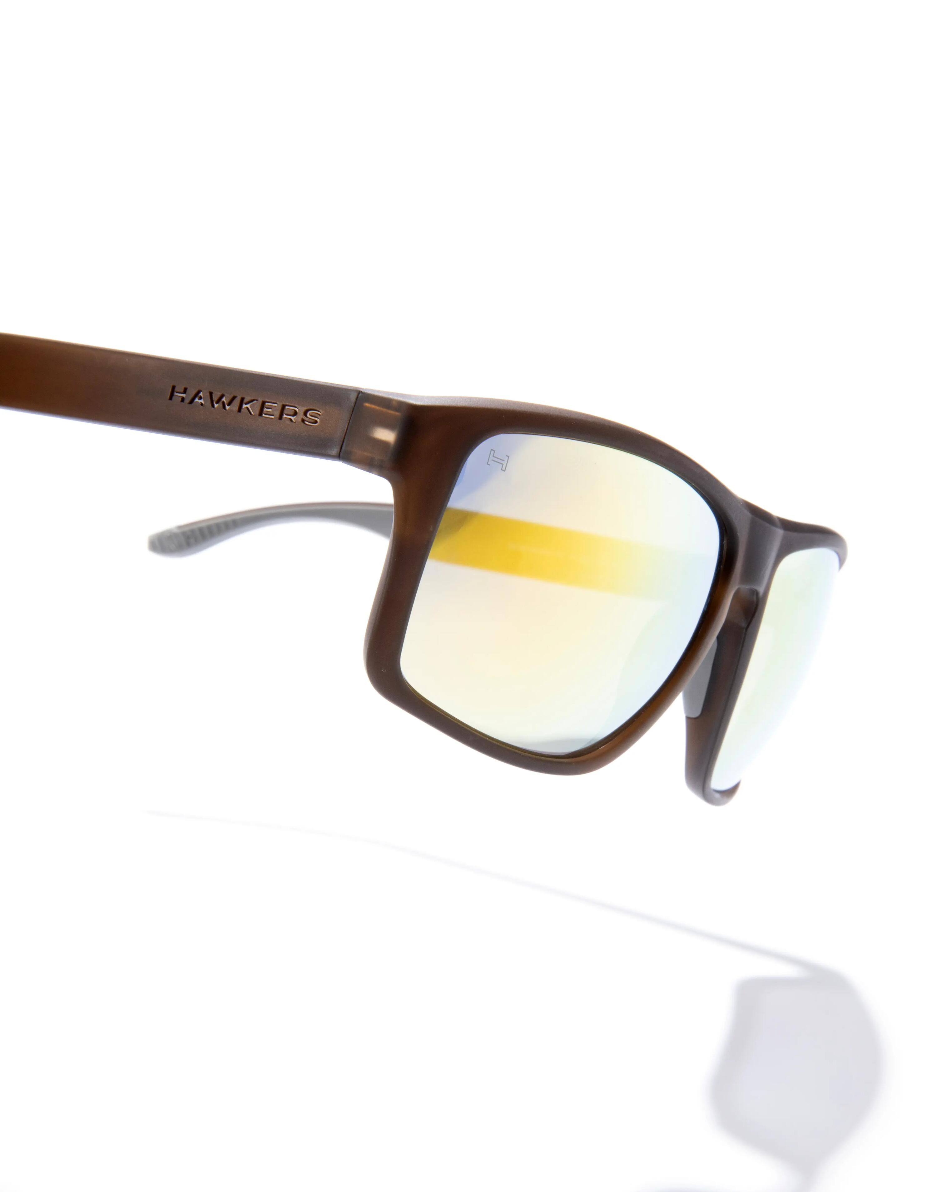HAWKERS - Occhiali da Sole per Uomo e Donna FASTER SPORT RAW - TERRA BROWN ACID 3/6
