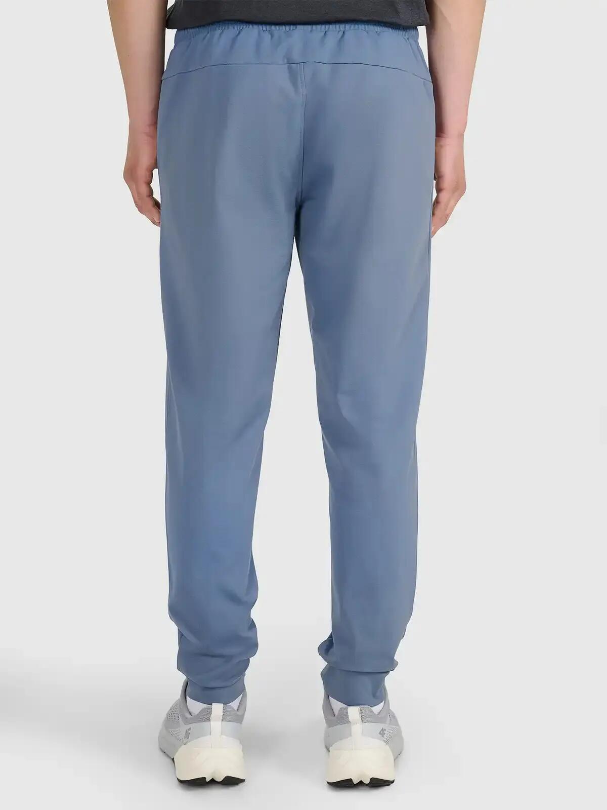 Spodnie treningowe z jednostronnie drapanej dzianiny męskie niebieskie 4F 2XL 6/7