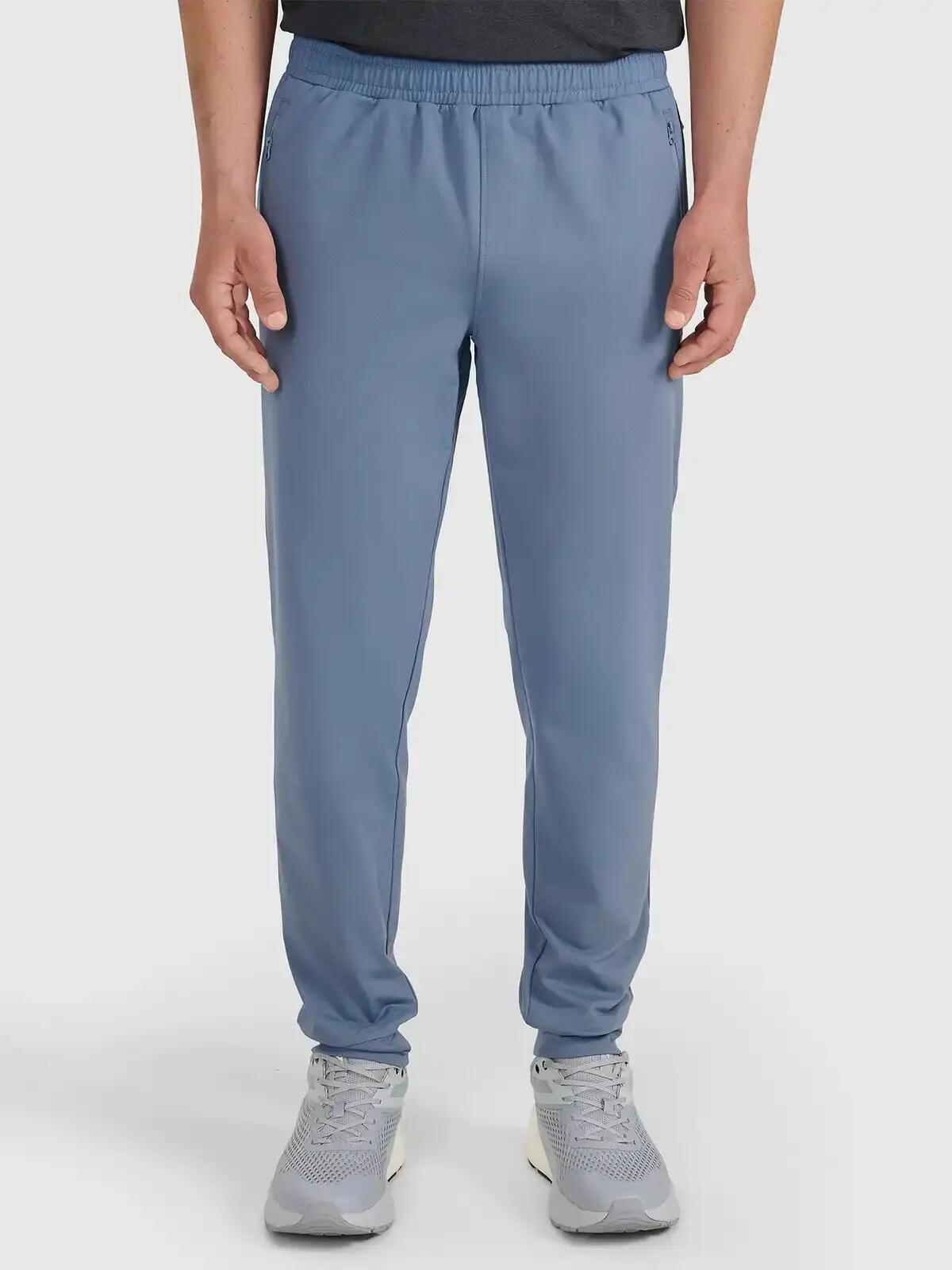 Spodnie treningowe z jednostronnie drapanej dzianiny męskie niebieskie 4F 2XL 5/7