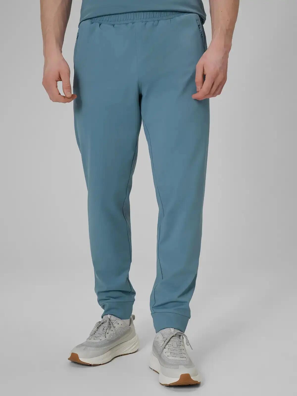 Spodnie treningowe z jednostronnie drapanej dzianiny męskie niebieskie 4F 2XL 4/7