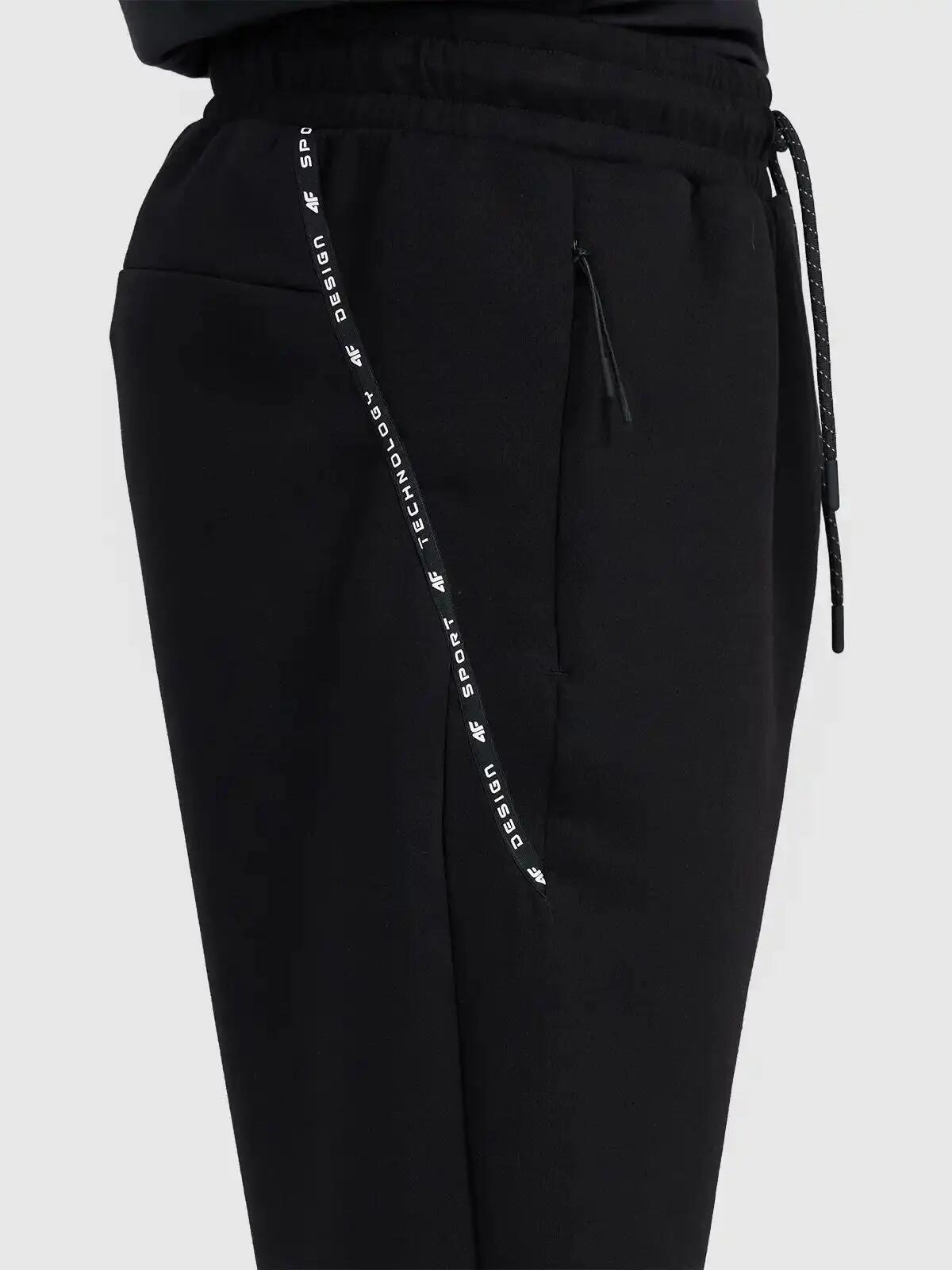 Spodnie treningowe joggery z technicznego materiału męskie czarne 4F Czarny XL 4/5