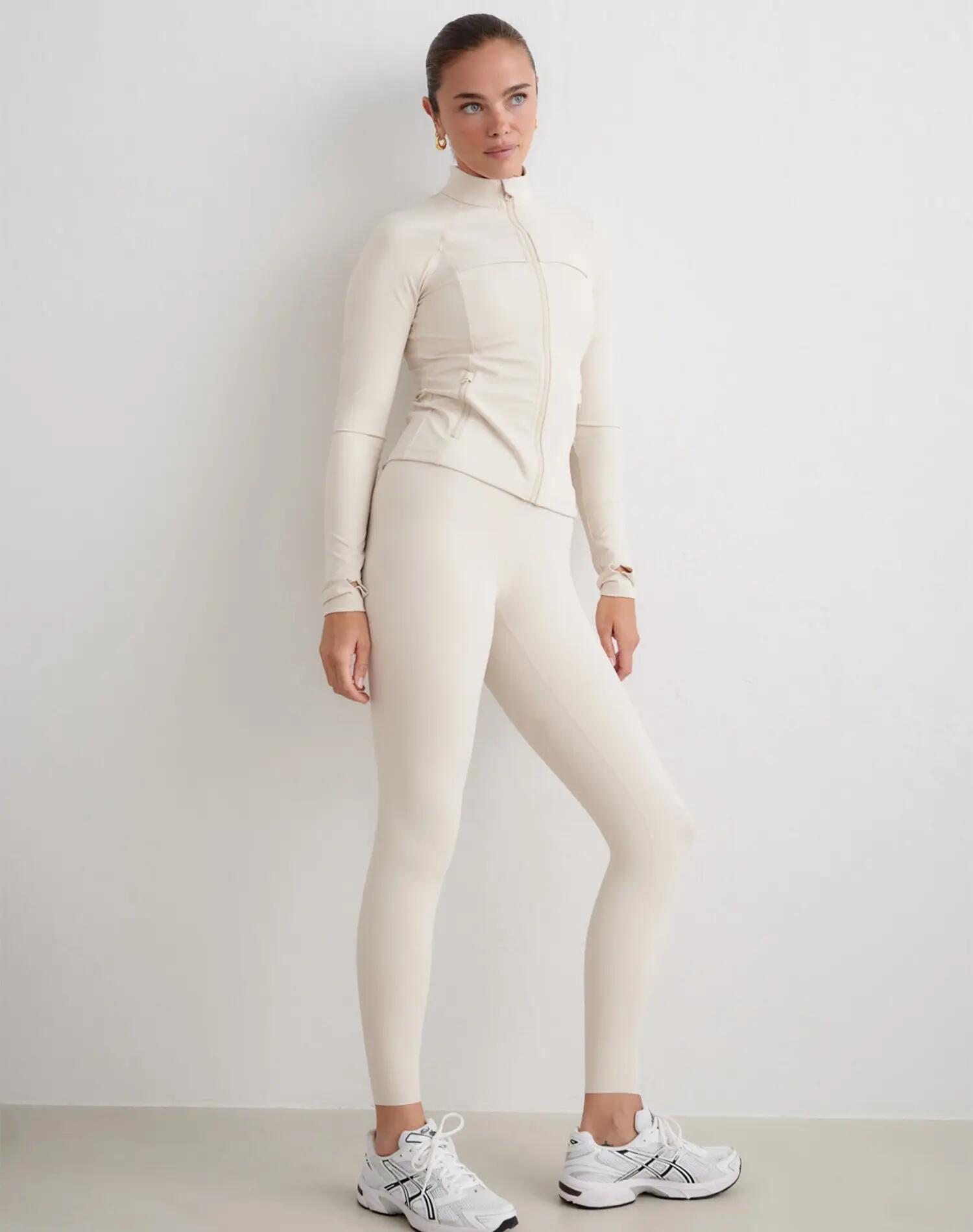 Dames sportjack compressie met rits vormgevend zand 4/5