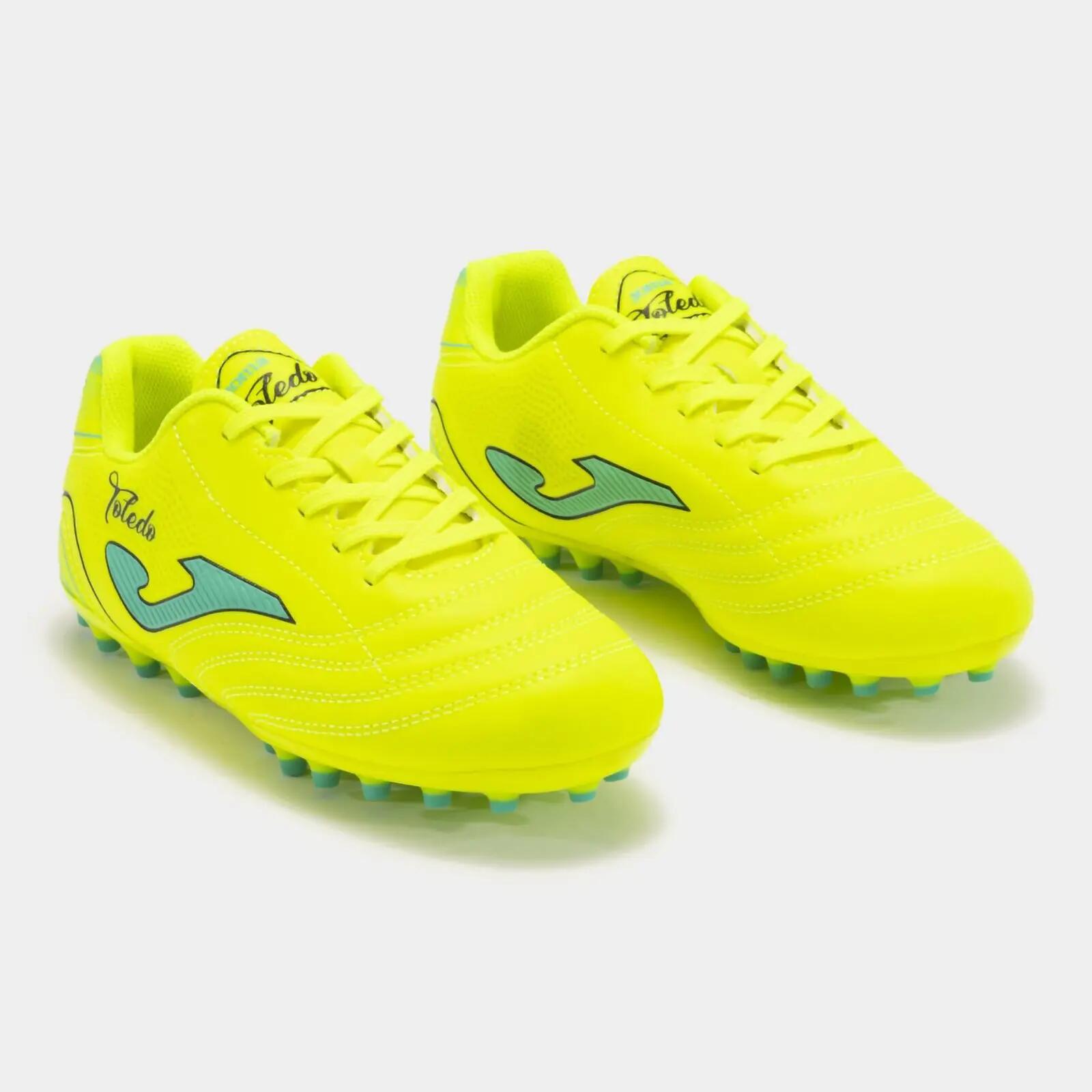 Deportivo Joma FUTBOL TOLEDO JR 2411 AMARILLO FLÚOR ARTIFICIAL GRASS CMSport 3/5