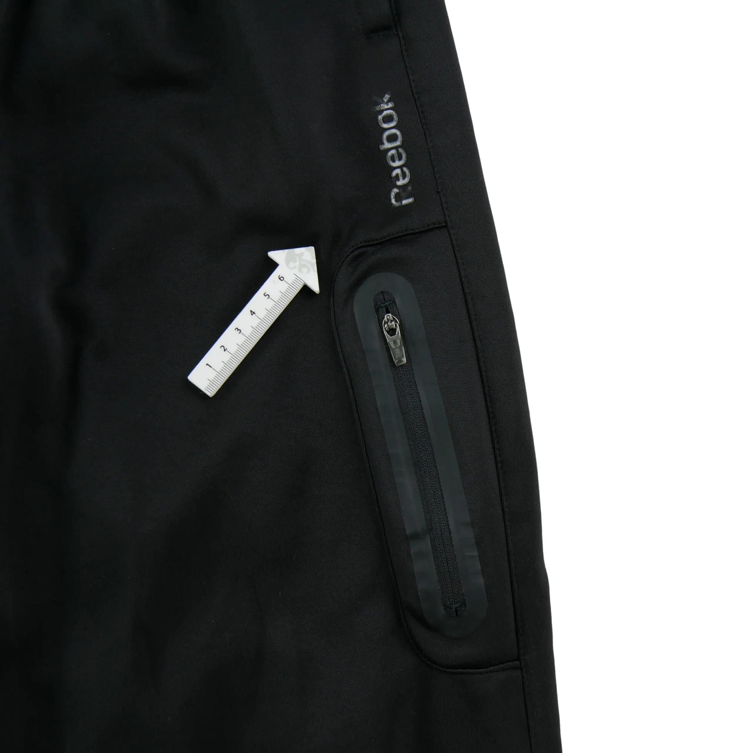 Heren joggingbroek met ritszak op het dijbeen zwart 6/7