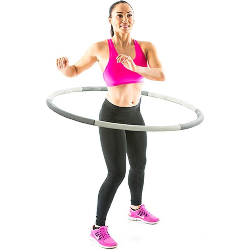 Niña deportiva haciendo ejercicios con un hula hoop foto de alta calidad