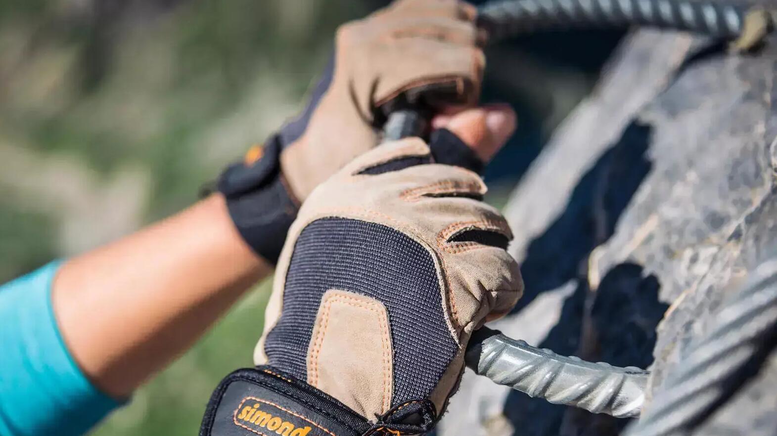 Eine Person trägt Klettersteighandschuhe am Berg