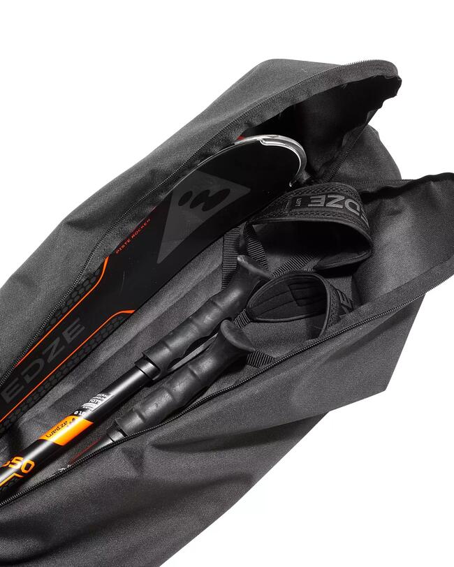 Die geöffnete Skitasche 100  gepackt mit einem Paar schwarzen WEDZE-Ski und einem Paar schwarzen WEDZE-Skistöcken