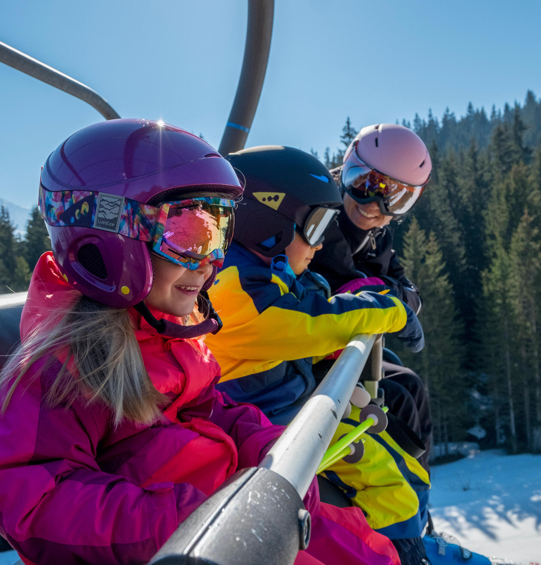 A family on a chairlift going up to the summit