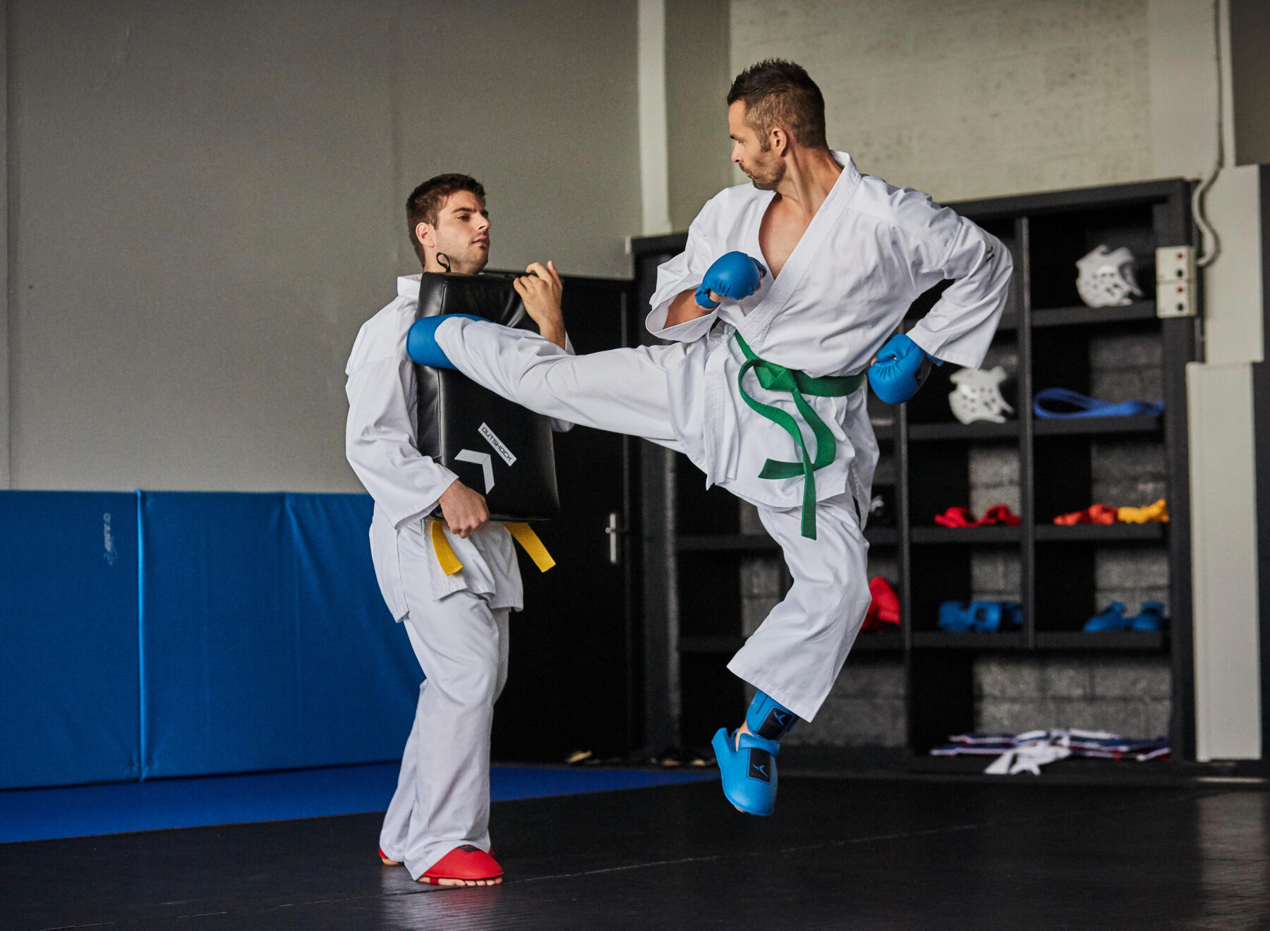 two men doing karate kicks