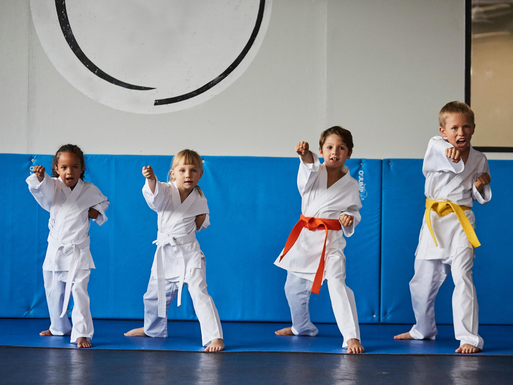 four children doing karate