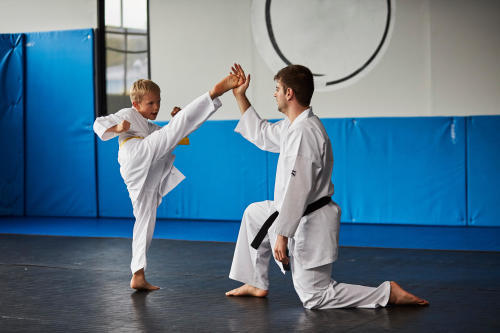 man and young boy practicing karate