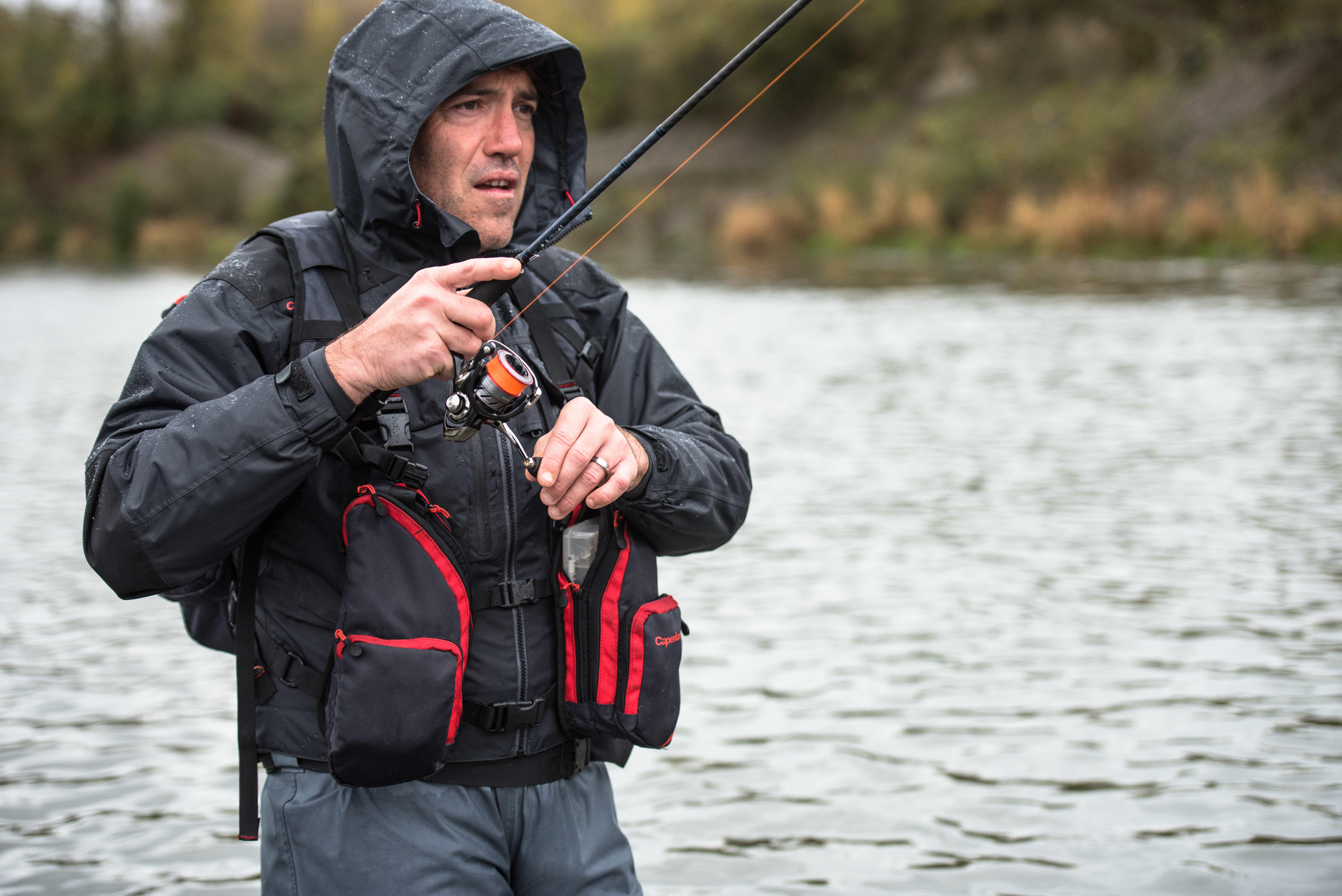 Angler wearing a fishing vest while casting on the water