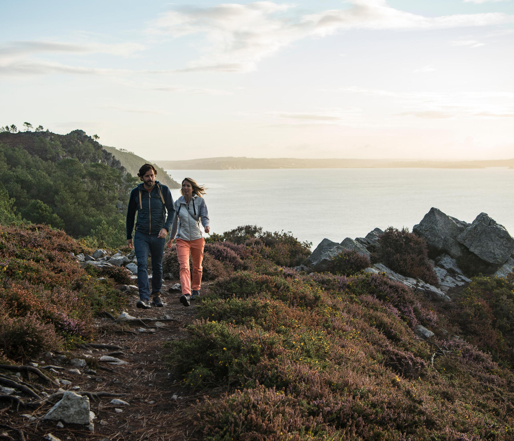 couple walking on the cliff overlooking the peninsula