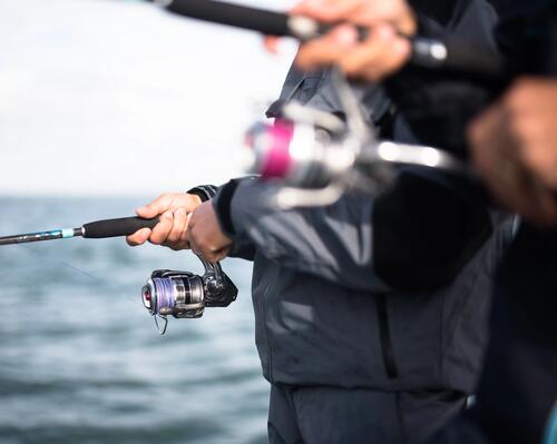 Close-up of man holding fishing reel