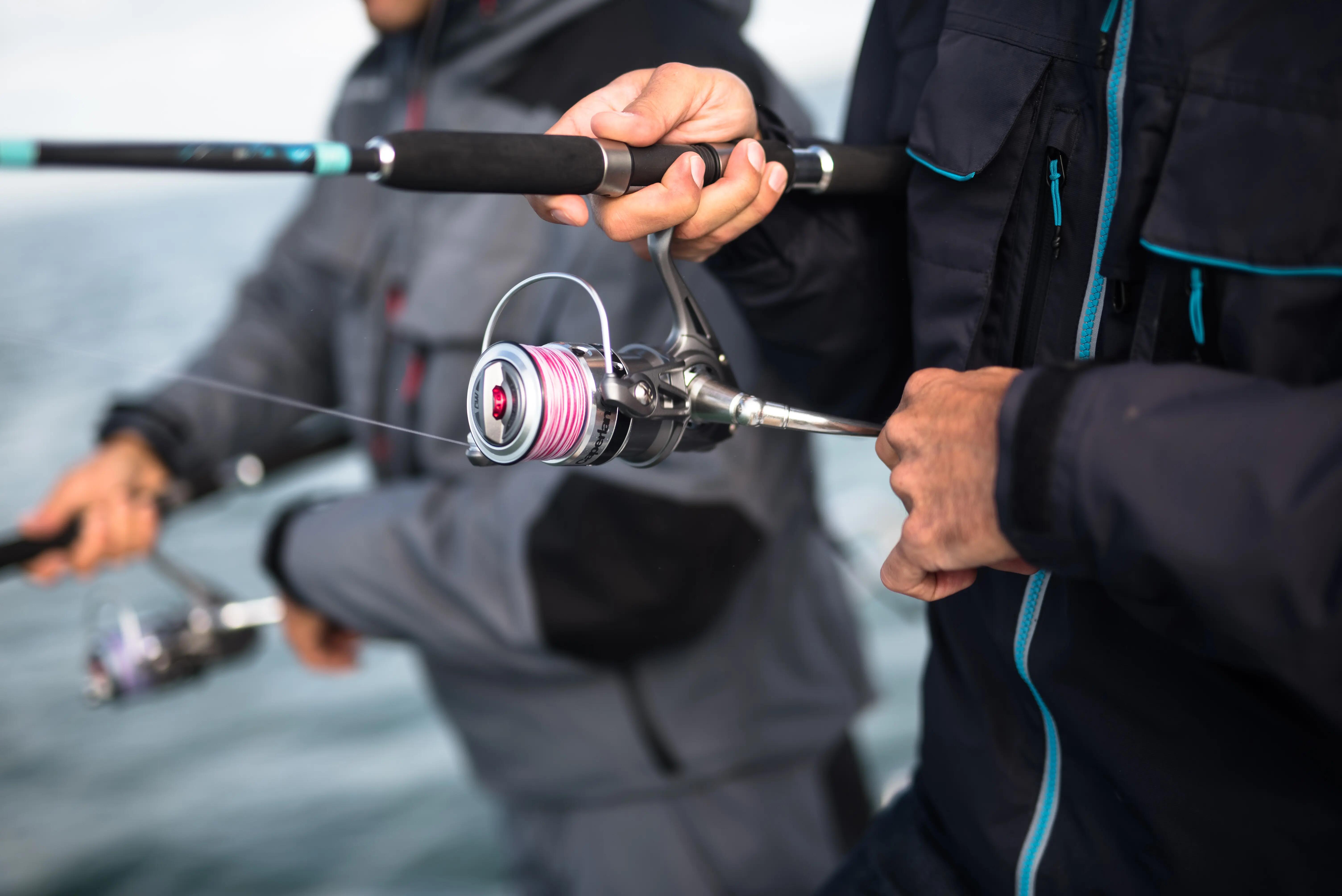 Angler holding a spinning fishing rod on a boat
