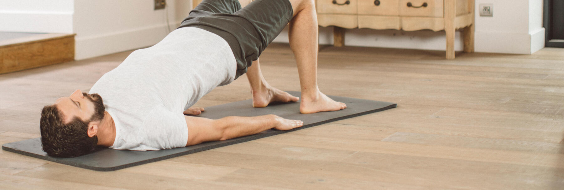 man stretching on a yoga mat