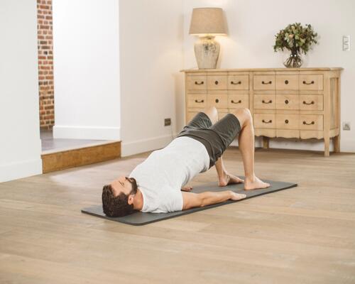 man doing yoga on a mat