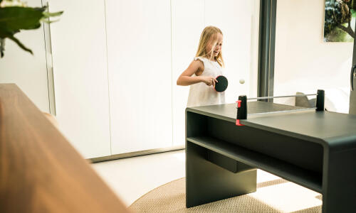 young girl playing ping pong