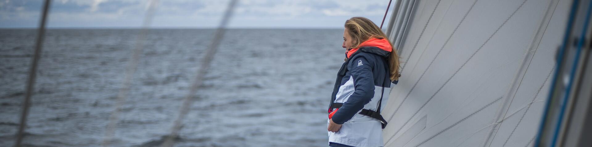 Woman wearing life jacket at shore