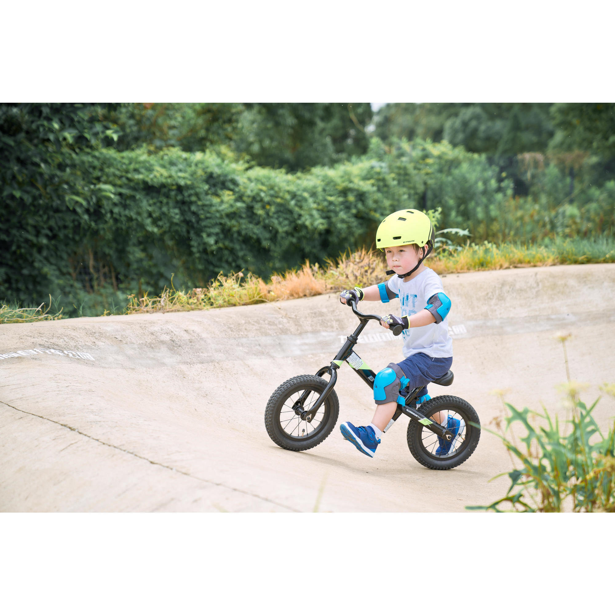 kid riding balance bike