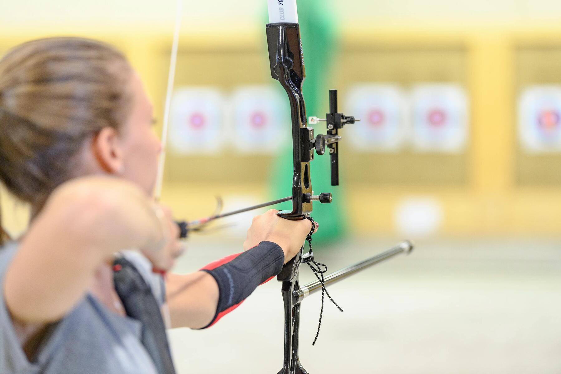 une femme au tir-à -'arc se préparant à viser la cible.