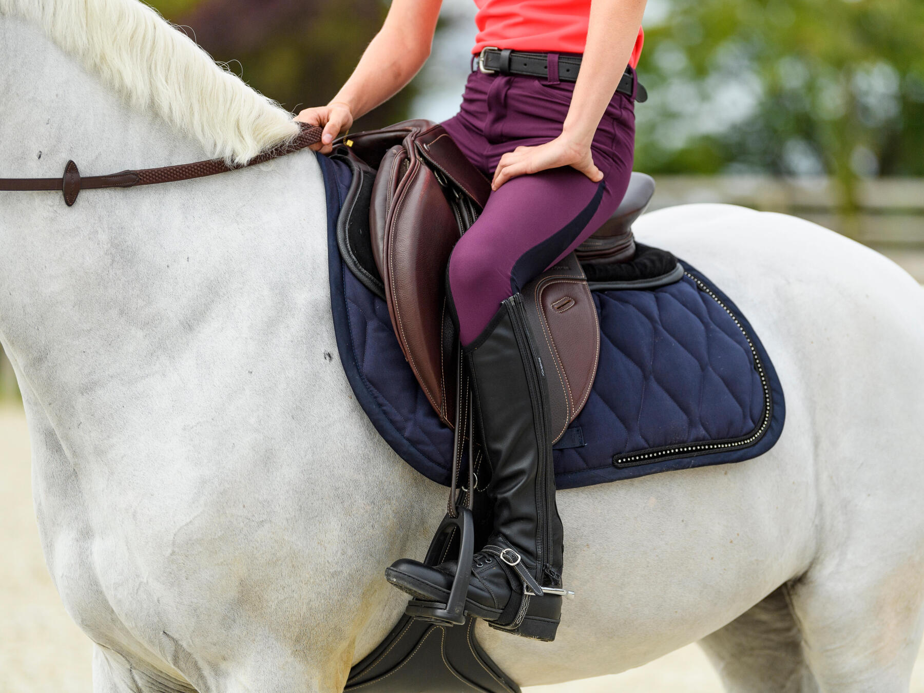 woman wearing riding pants while horseback riding