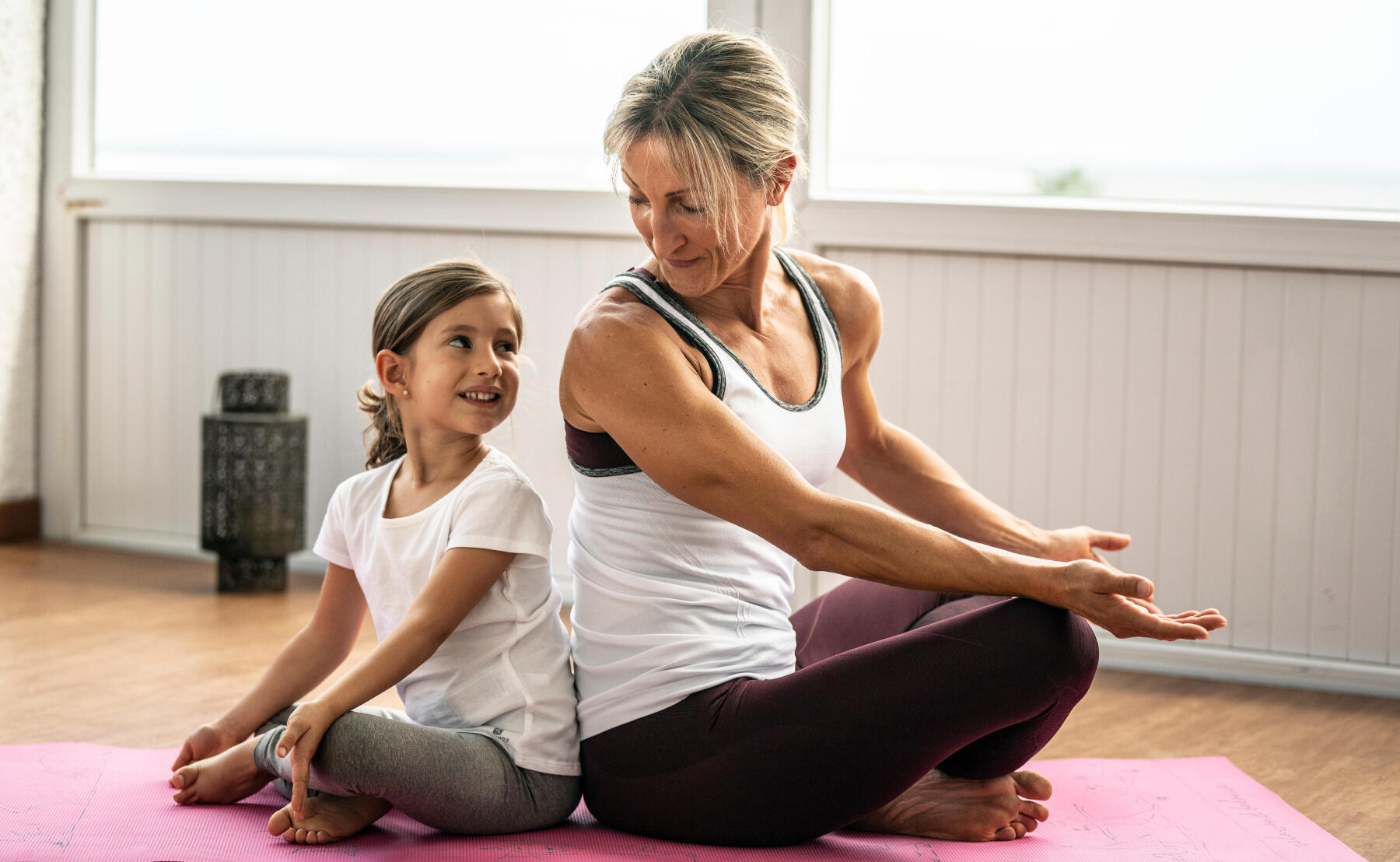 Mother and daughter do yoga 