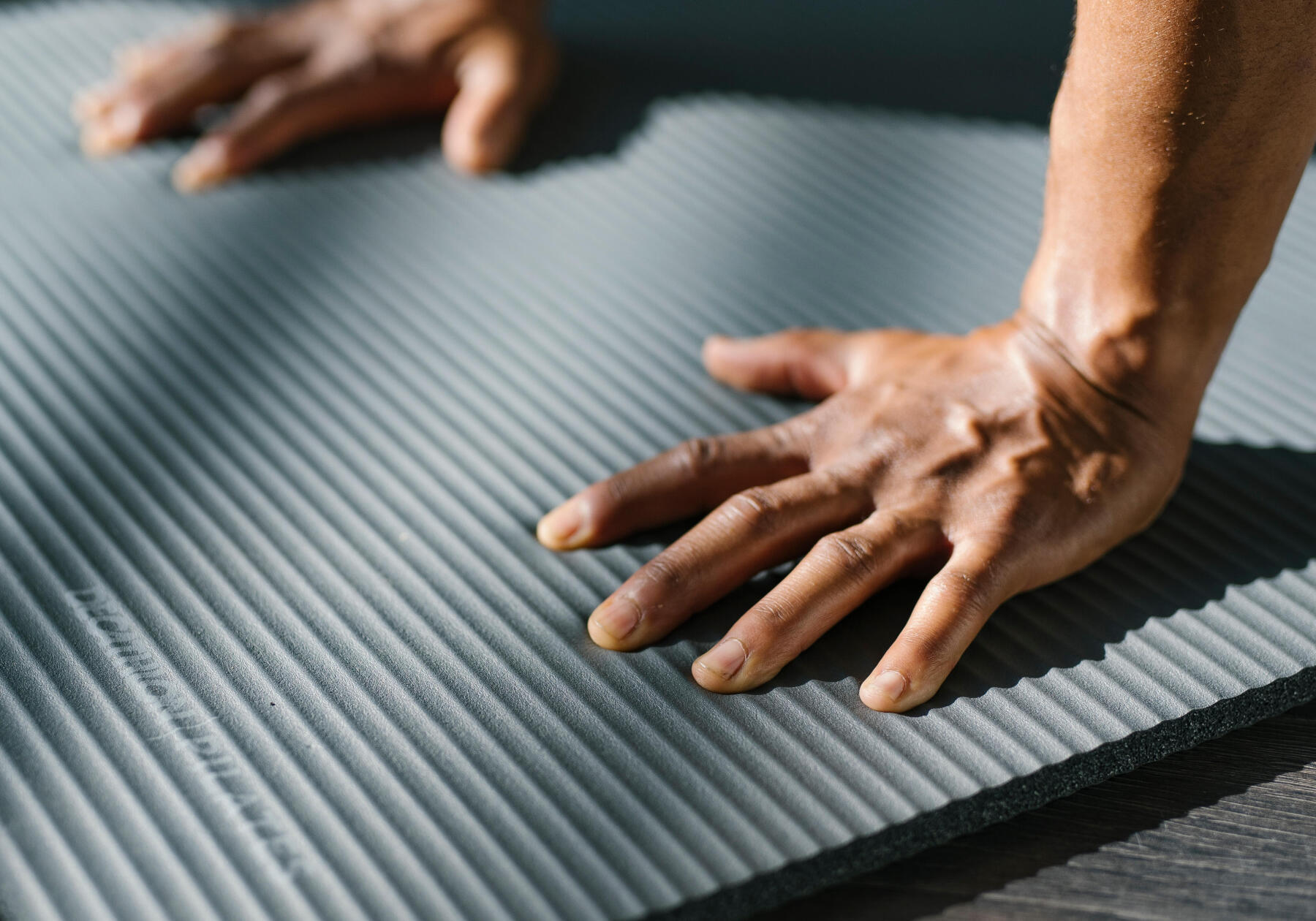 man holding a pose on his soft mat