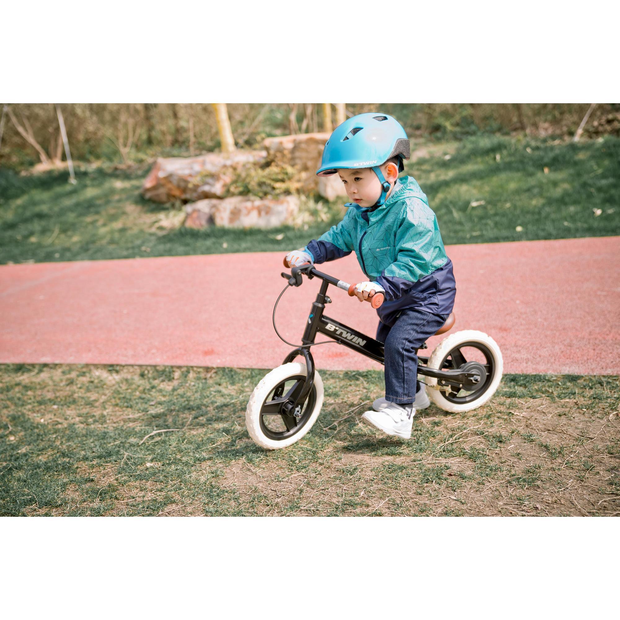 kid riding balance bike