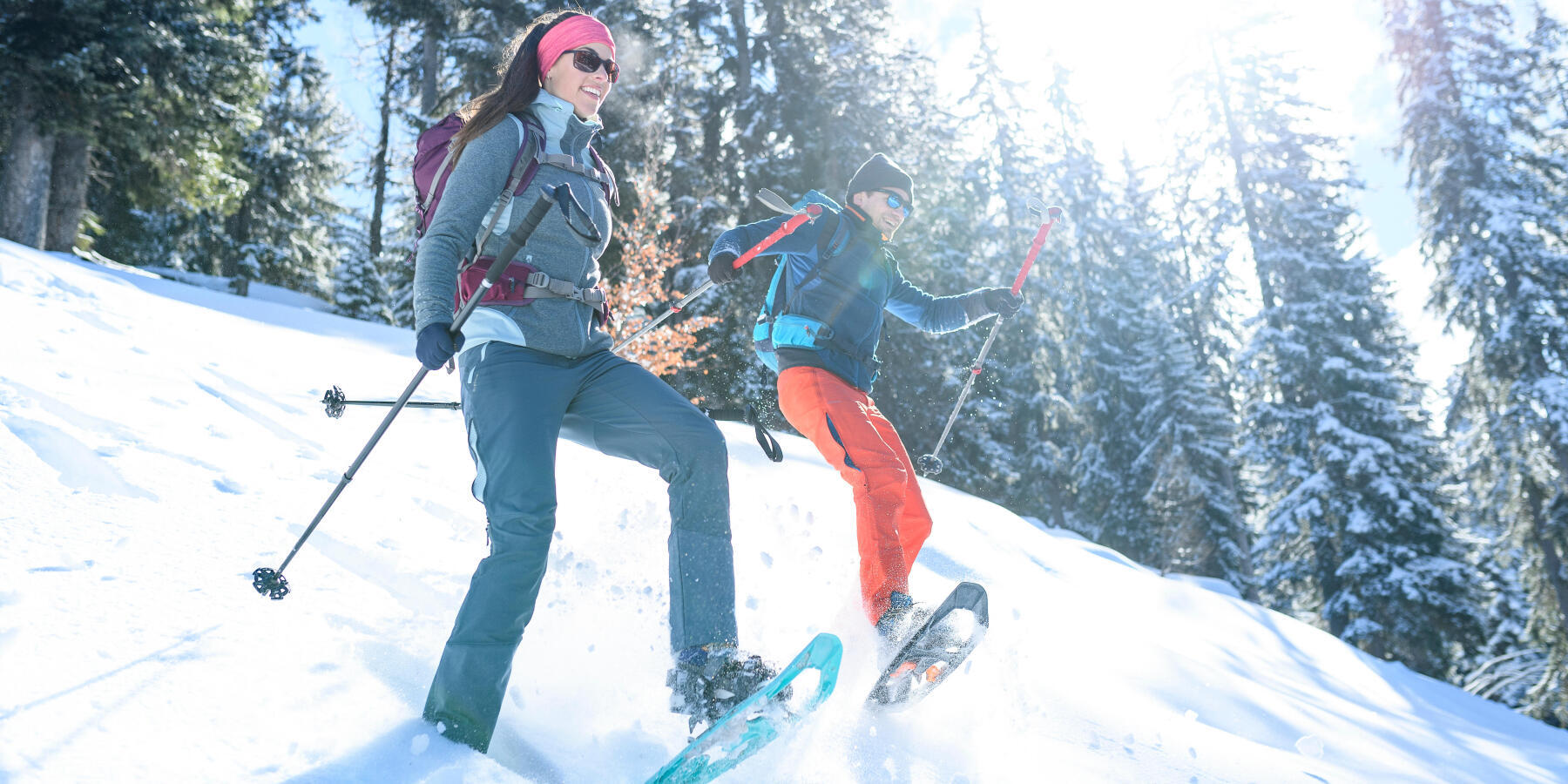 Couple on a mountain descent with snowshoes