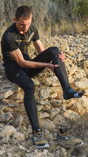 Man puts orienteering socks Man puts orienteering socks