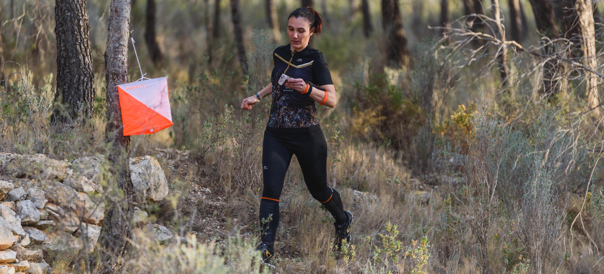 Orienteering woman punchs control