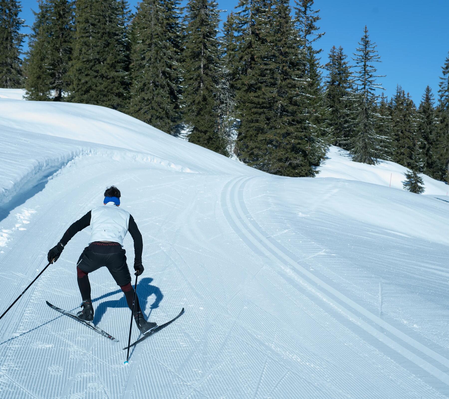 person going uphill on cross-country skis