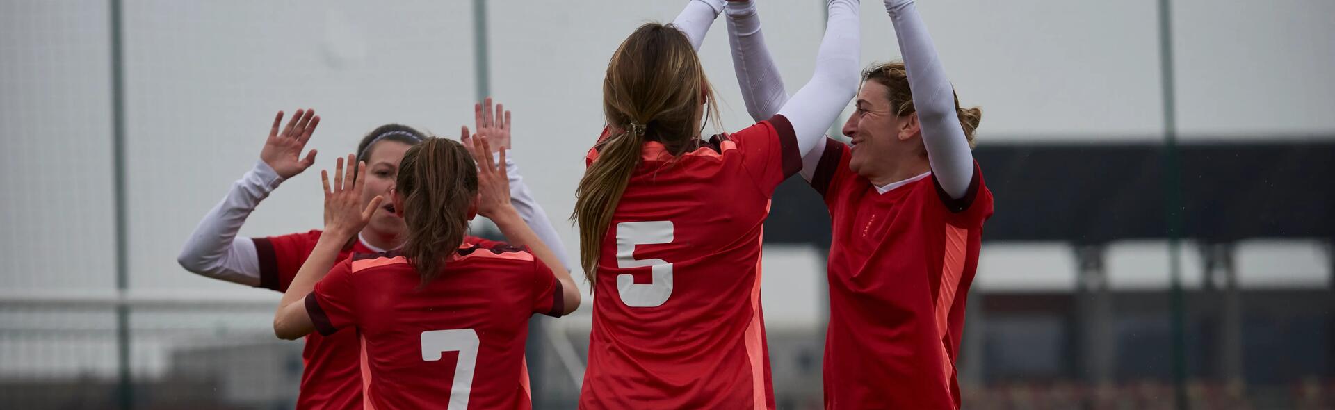 women celebrating a goal during a soccer game