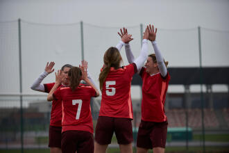 women celebrating a goal during a soccer game
