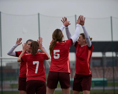 women celebrating a goal during a soccer game