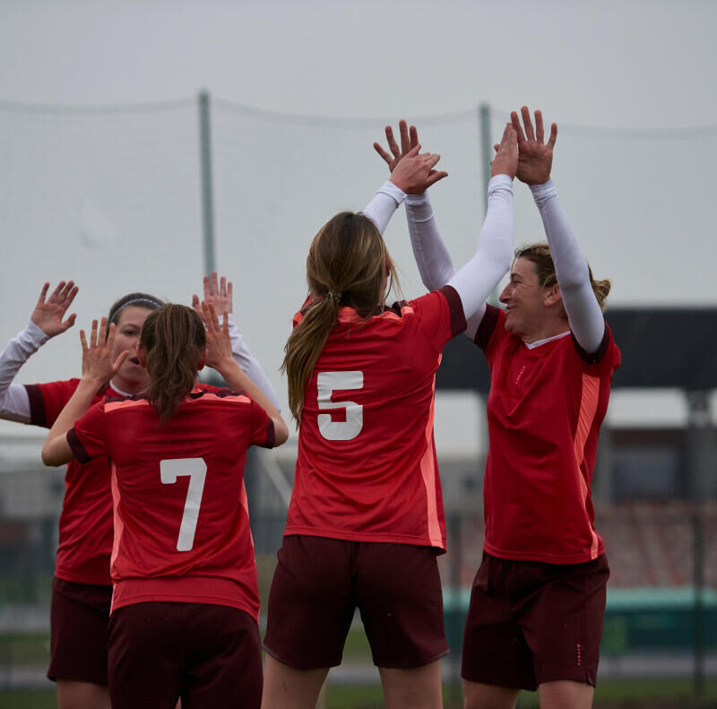 women celebrating a goal during a soccer game