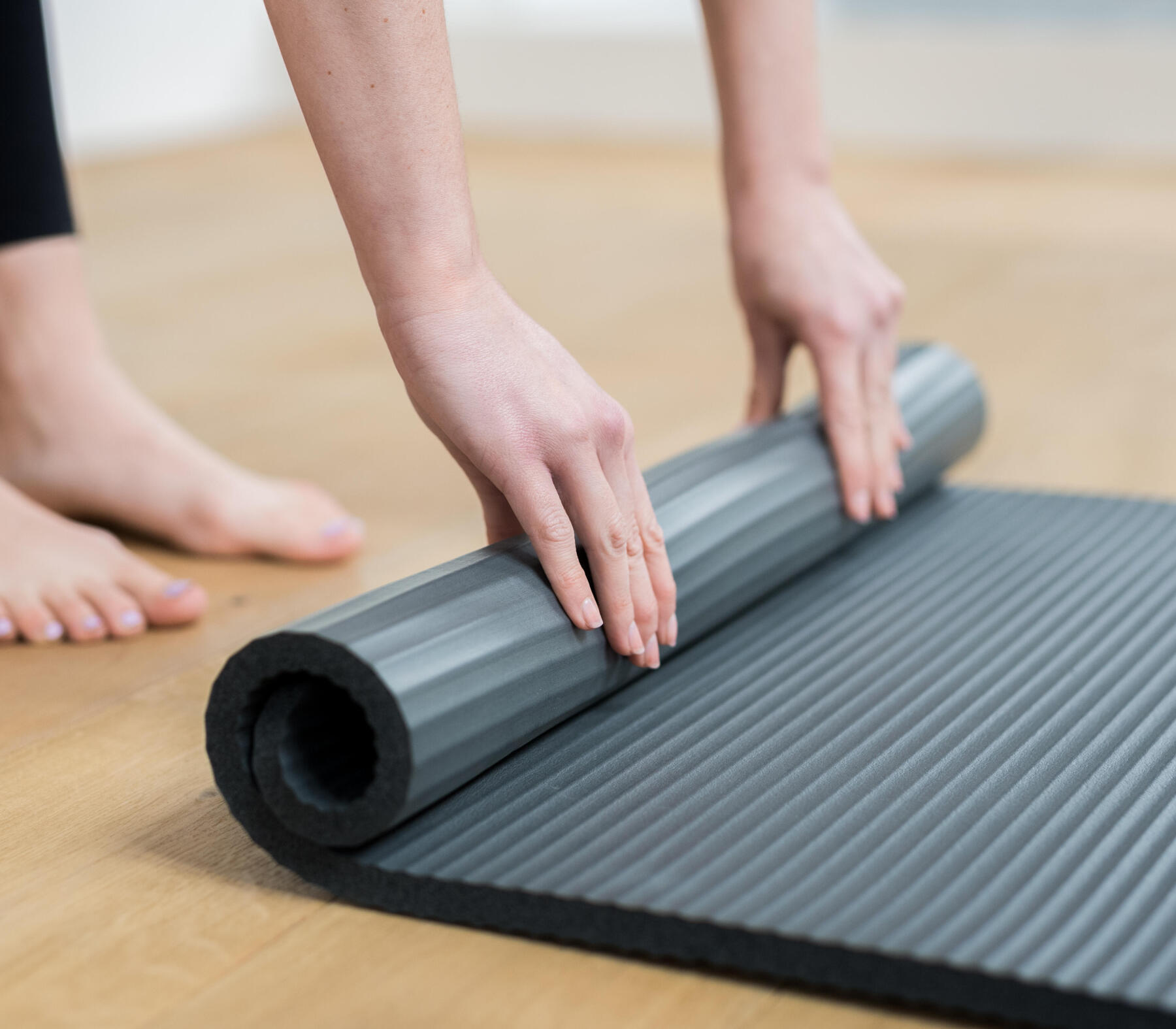woman rolling her mat