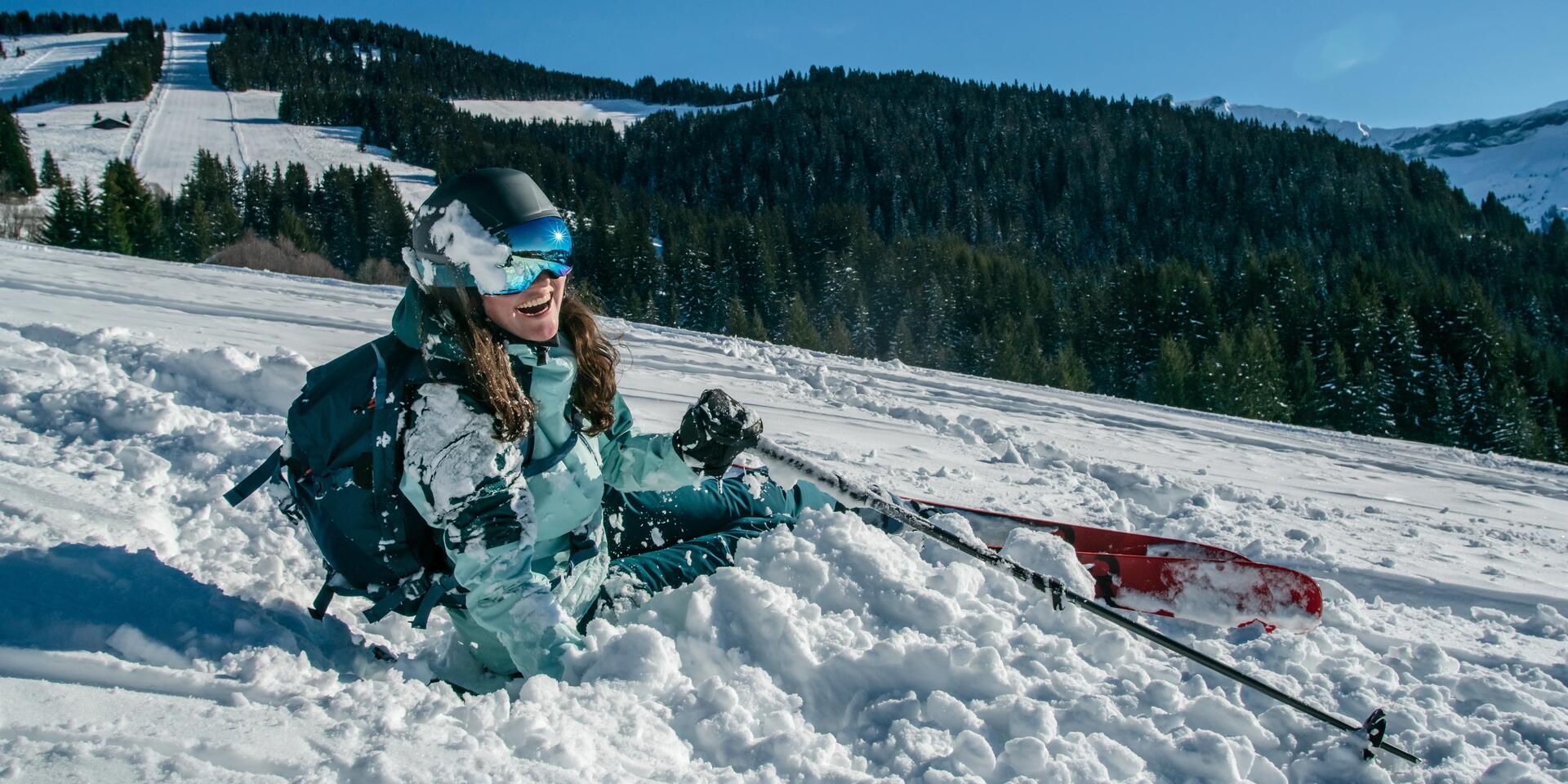 A beginner skier in the snow after falling over