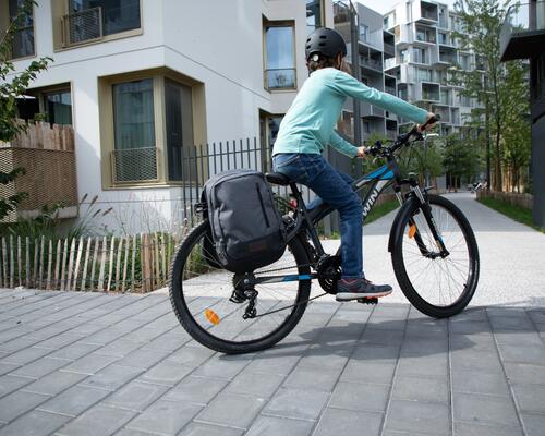 A child riding a MTB with pannier rack