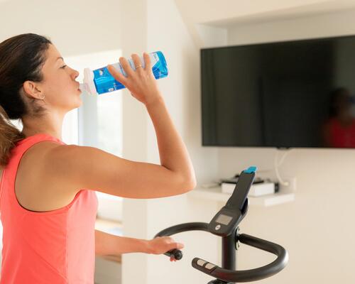 Woman drinking water during a workout session